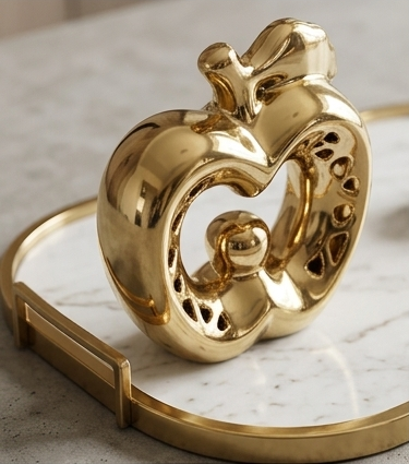 Glossy gold ceramic apple statue