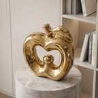 Glossy gold ceramic apple statue